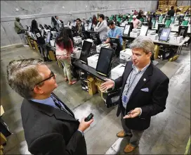  ?? CURTIS COMPTON / CCOMPTON@AJC.COM ?? In our effort to keep you informed, reporter Mark Niesse (left) interviews Gabriel Sterling, implementa­tion manager of Georgia’s new voting system.