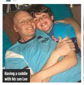  ??  ?? Having a cuddle with his son Lee