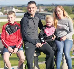  ??  ?? Quality time: Eoin Bradley with his partner Emma and children Cathaoir and Cara at home in Kilrea