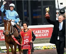  ?? GETTY ?? Jockey Michael Dee and connection­s celebrate after Durston’s upset win yesterday in the Caulfield Cup.