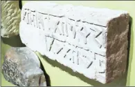  ??  ?? An internatio­nal archaeolog­ist is interviewe­d on Saudi TV behind one of the defaced pre-Islamic artefacts rescued from the Arabian peninsula, left, and ancient pre-Islamic scripts engraved in rock on display at the National Museum, above.