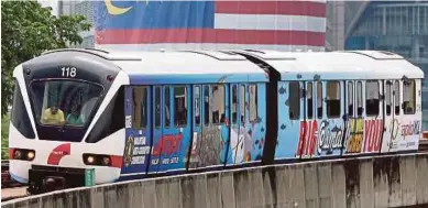  ?? PIC BY ZULFADHLI ZULKIFLI ?? A light rail transit train bearing the ‘Big or Small We Will Catch You’ message in Kuala Lumpur yesterday.