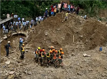  ??  ?? Rescuers retrieve a body they recovered at the site where victims are believed to have been buried by a landslide after Typhoon Mangkhut lashed Itogon, Benguet province, northern Philippine­s on Monday. AP PhoTo/AAron FAVIlA