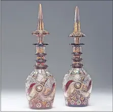  ?? [COWLES SYNDICATE] ?? These 19th-century Bohemian glass decanters were blown, flashed with red glass, cut, and then decorated with orange and black enamel and gilt. The 20-inch-high pair auctioned for $1,920.