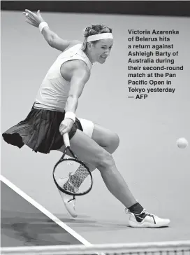  ??  ?? Victoria Azarenka of Belarus hits a return against Ashleigh Barty of Australia during their second-round match at the Pan Pacific Open in Tokyo yesterday — AFP
