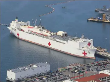  ?? Sean M. Haffey Getty Images ?? THE NAVY will send two hospital ships to help backstop strained healthcare systems. The Mercy, above, will be ready to sail from San Diego within days, probably staying on the West Coast, officials say.