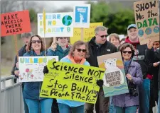  ?? SARAH GORDON/THE DAY ?? Participan­ts chant “Science not silence” as they walk along the Niantic Bay Boardwalk during Southeaste­rn Connecticu­t’s March for Science on Saturday. The march was part of a national Earth Day event to support science and advocate for science-based...