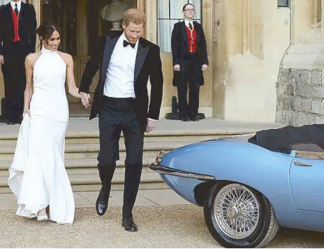  ??  ?? The new Duke and Duchess of Sussex head to their evening reception at Frogmore House: The 1968 Jaguar E-Type Concept Zero they rode in was converted into using electric power, an eco-friendly choice for the couple.