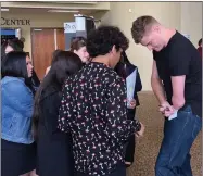  ?? RECORDER PHOTO BY ESTHER AVILA ?? Keynote speaker Kevin Atlas signs autographs for students on Friday at Portervill­e Church of the Nazarene.