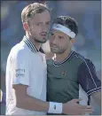  ?? MARK J. TERRILL — THE ASSOCIATED PRESS ?? Grigor Dimitrov, right, embraces Daniil Medvedev after winning Wednesday’s match at the BNP Paribas Open.