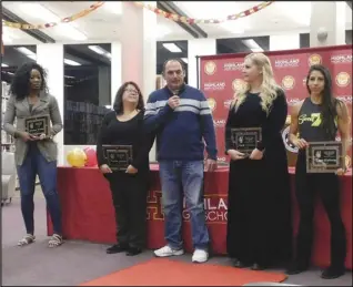  ?? MERISA JENSEN/Valley Press ?? SPEECH — Tony Garcia, center, comments about the accomplish­ments of his daughter, Rachel Garcia, who was inducted into the Highland Hall of Fame on Friday, as his wife, Christine Garcia, second from left, looks on along with other inductees Jessica Davis, left, April Corrigan Graves, second from right, and Tiana Webberly, right.