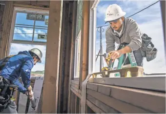  ?? DAVID PAUL MORRIS, BLOOMBERG NEWS ?? Contractor­s install a window on a home in San Ramon, Calif., last month. Housing starts are set for release onWednesda­y.