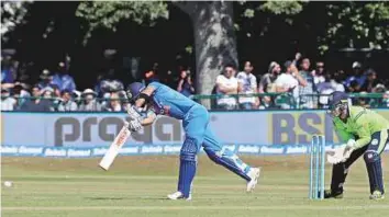  ?? Donall Farmer/PA Wire ?? Virat Kohli guides one to mid-on during the second Twenty20 internatio­nal against Ireland at Malahide, Dublin. India won by 143 runs to complete a 2-0 victory.