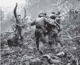  ?? ASSOCIATED PRESS FILE PHOTO ?? The first sergeant of A Company, 101st Airborne Division, guides a medevac helicopter through the jungle foliage to pick up casualties suffered during a five-day patrol near Hue, Vietnam, in April 1968.