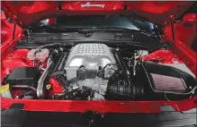  ?? Associated Press photo ?? The 2018 Dodge Challenger SRT Demon’s open hood shows its engine during a media preview for the New York Internatio­nal Auto Show in New York.