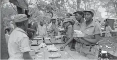  ??  ?? Female Zipra combatants being served a meal at Mkushi Camp in Zambia. (Picture courtesy of the late Zenzo Nkobi)