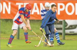  ?? Photograph: Neil Paterson. ?? Newtonmore keeper Norman Campbell prevents Kingussie’s Lee Bain from getting a shot on target.