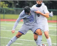  ?? GEORGE SPITERI — FOR THE MACOMB DAILY ?? Gjon Melakuqi (19) of Eisenhower and Thomas James of Dakota try to control the ball during a MAC Red match Monday. The teams tied 1-1.