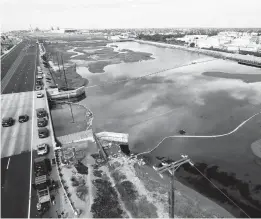  ?? RINGO H.W. CHIU/AP ?? An aerial photo Monday shows booms put in place to try to stop further incursion into the Wetlands Talbert Marsh after an oil spill in Huntington Beach, Calif.