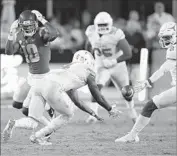  ?? Mark J. Terrill Associated Press ?? TEXAS’ DeShon Elliott grabs a pass def lected by USC’s Jalen Greene (10) and turns it into a pick-six.