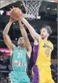  ?? Jae C. Hong Associated Press ?? MACCABI HAIFA’S Dijon Thompson gets his shot blocked by the Lakers’ Ryan Kelly.