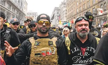  ?? STEPHANIE KEITH GETTY IMAGES ?? Proud Boys leader Enrique Tarrio (left) and Proud Boys organizer Joe Biggs lead a Dec. 12 protest in Washington on the day of the Electoral College vote certifying Joe Biden as winner of the Nov. 3 election.