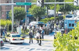  ?? (AP) ?? POLICE secure the scene of a shooting at an office building housing The Capital Gazette newspaper in Annapolis, Maryland.