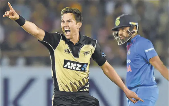  ?? AFP ?? Trent Boult (left) appeals successful­ly to have Rohit Sharma caught behind during the second T20I in Rajkot on Saturday. New Zealand won by 40 runs.