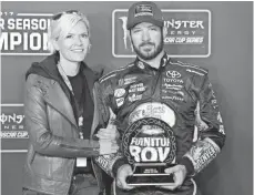  ?? PETER CASEY, USA TODAY SPORTS ?? Martin Truex Jr. and his girlfriend, Sherry Pollex, celebrate his regular-season title, which gives him the No. 1 playoff seed.