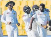  ?? AFP ?? Rangana Herath (right) played a pivotal role in Sri Lanka’s win.