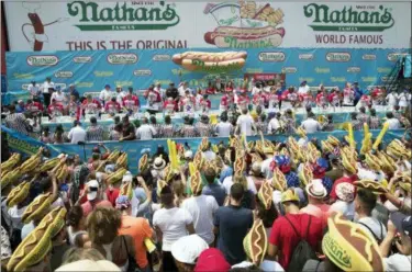  ?? THE ASSOCIATED PRESS ?? The audience watches the men’s competitio­n of the Nathan’s Famous Fourth of July hot dog eating contest, Wednesday in New York’s Coney Island.