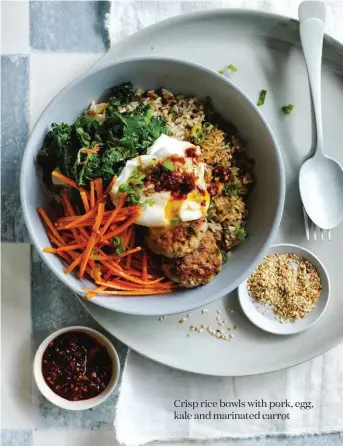  ??  ?? Crisp rice bowls with pork, egg, kale and marinated carrot