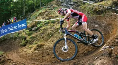 ??  ?? Kabush at the 2010 mountain bike world championsh­ips in MontSainte-anne, Que., riding a Rocky Mountain