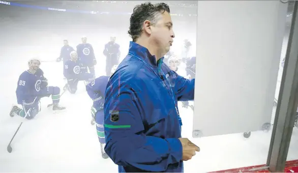  ?? JEFF VINNICK/NHLI/GETTY IMAGES ?? Canucks head coach Travis Green explains a drill during practice at Mercedes-Benz Arena on Tuesday in Shanghai. They play the Kings today.