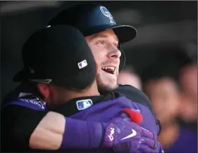  ?? AP PHOTO DAVID ZALUBOWSKI ?? Colorado Rockies' Trevor Story is congratula­ted as he returns to the dugout after hitting a solo home run off Philadelph­ia Phillies starting pitcher Jake Arrieta in the second inning of a baseball game Thursday in Denver.