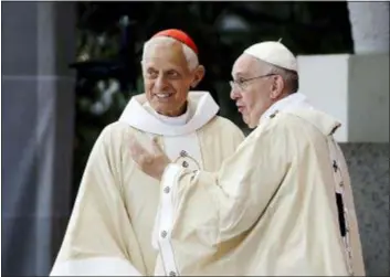  ?? DAVID GOLDMAN - THE AP ?? This 2015 photo shows Cardinal Donald Wuerl, archbishop of Washington, left, talking with Pope Francis after a Mass in the Basilica of the National Shrine of the Immaculate Conception in Washington. Pope Francis has accepted Friday, the resignatio­n of Washington Cardinal Donald Wuerl after he became entangled in two major sexual-abuse and cover-up scandals and lost the support of many in his flock.