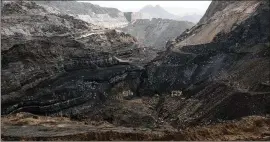  ?? GILLES SABRIE / NEW YORK TIMES 2014 ?? A defunct open-pit coal mine in China’s Shanxi province. The United States’ move back to fossil fuels and away from alternativ­e energy has now put China in a position of environmen­tal leadership as it increases its use of renewable resources to supply...