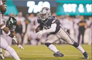  ?? The Associated Press ?? CONVERSATI­ON SHIFT: Dallas Cowboys’ Ezekiel Elliott, right, runs the ball for a touchdown during the second half of Sunday’s game against the New York Jets in East Rutherford, N.J.