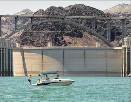  ?? Allen J. Schaben Los Angeles Times ?? LAKE MEAD, created by Hoover Dam, entices boaters to take a plunge on a July day. The reservoir doubles as a recreation area.