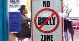  ?? SUN-TIMES MEDIA ?? A “No Bully Zone” sign hangs on the door of a school classroom.