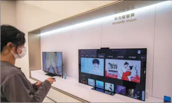  ?? PROVIDED TO CHINA DAILY ?? A shopper tries a Huawei TV, which is installed with HarmonyOS, at Huawei’s flagship store in Shanghai.