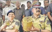  ?? PTI ?? Police commission­er Anjani Kumar shows to media the threetier golden tiffin box and the gold cup and plate after their recovery, in Hyderabad on Tuesday.