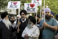  ?? KIRSTY WIGGLESWOR­TH — THE ASSOCIATED PRESS ?? Members of the Manchester Sikh Community attend a vigil in Albert Square, Manchester, England, Tuesday the day after the suicide attack at an Ariana Grande concert that left 22people dead as it ended on Monday night.