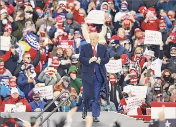  ?? Rey Del Rio / Getty Images ?? President Donald Trump arrives for a campaign rally on Saturday in Muskegon, Mich. Trump has ramped up his schedule as he continues to campaign ahead of the November election.