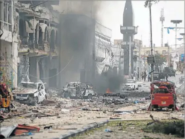  ?? Picture: REUTERS ?? BLAST DEVASTATIO­N: This is the scene of a secondary explosion in front of the Dayah Hotel in Mogadishu