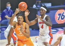  ?? AP PHOTO/MATT STAMEY ?? Tennessee senior Yves Pons shoots with Florida’s Anthony Duruji defending during Tuesday night’s 75-49 loss to the Gators.