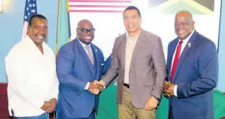  ?? PHOTO BY DERRICK SCOTT ?? Prime Minister Andrew Holness (second right) receives a warm welcome from Dr Tony Allen, president of the Delaware State University (DSU), as he arrives at the university on Thursday to attend a luncheon given in his honour. Sharing in the occasion are Member of Parliament
nd for St Mary Western Robert Montague (left) and Senior Vice-President for DSU Antonio Boyle.