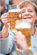  ?? EUROPEAN PRESS AGENCY ?? German Chancellor Angela Merkel toasts supporters during an election campaign event on Sunday. Without naming him, Merkel appeared to be critical of President Donald Trump’s agenda at the Group of Seven summit meetings last week.