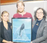  ?? MITCH MACDONALD/THE GUARDIAN ?? Marine Animal Response Society Tonya Wimmer, from left, Save Our Seas and Shores P.E.I. chair Colin Jeffrey and Sierra Club Canada Foundation national program director Gretchen Fitzgerald up a painting of a whale following a fundraiser at UPEI on...