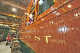  ?? LEAH HENNEL ?? Colonist car restoratio­n project donor Joan Snyder sits inside the now fully restored 1905 colonist rail car at Heritage Park on Thursday.